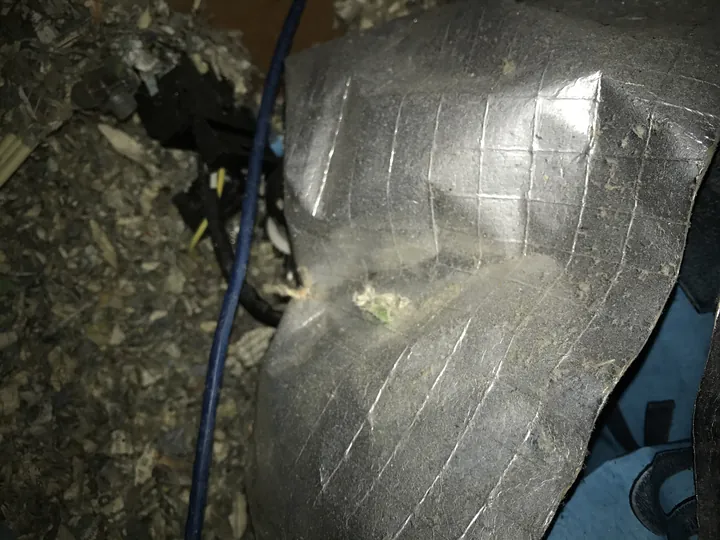 Loose cellulose pumped right up against taped ductwork and wiring with no fire clearance kept, the kind of unqualified work Comfort Zone never does