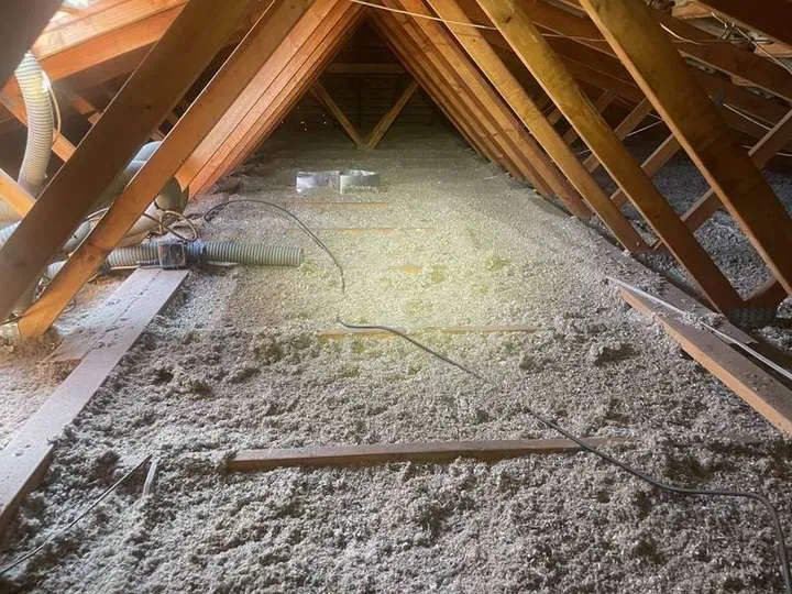 Grey cellulose insulation blanket covering a ceiling around ducting and cabling under a timber roof, Comfort Zone, Laidley QLD