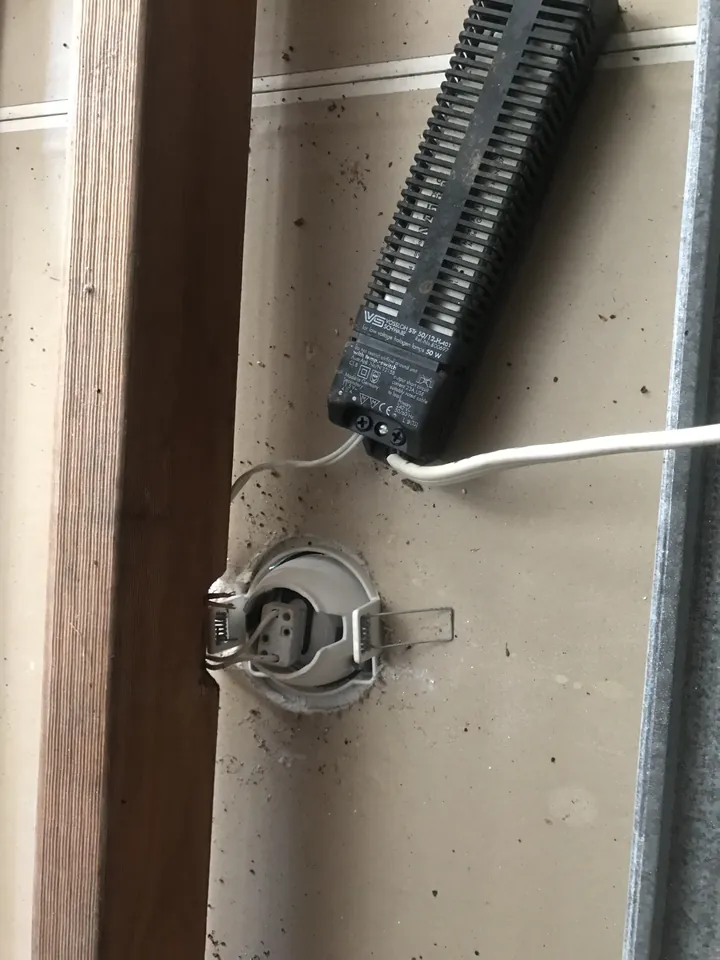 A fire-rated downlight viewed from inside the ceiling, safe to insulate over, Comfort Zone