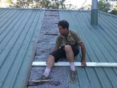 Peter Johnson installing cellulose on a Colorbond roof, Bellmere job