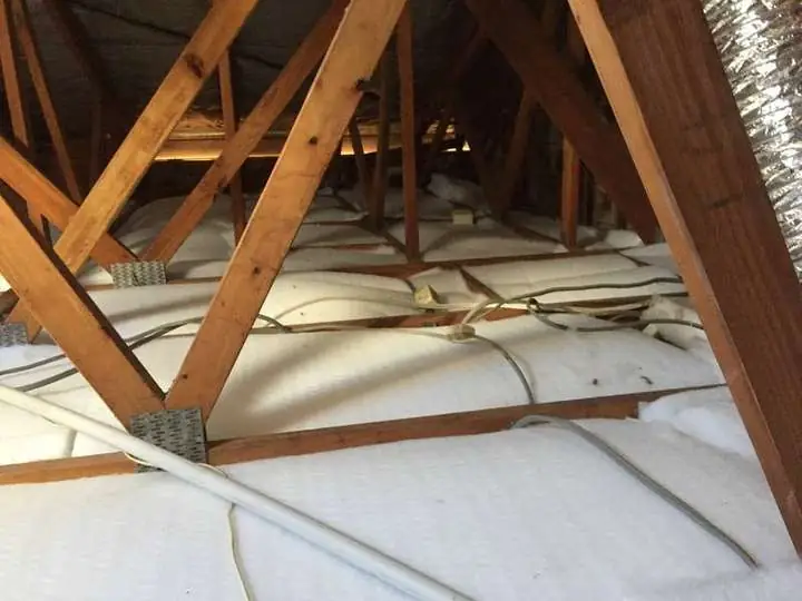 Clean white polyester batts laid evenly across a ceiling under a tiled roof, Comfort Zone, Chapel Hill