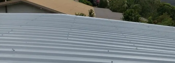 A low-pitch flat iron roof where the metal sheets wrap over from one side to the other, usually with no manhole