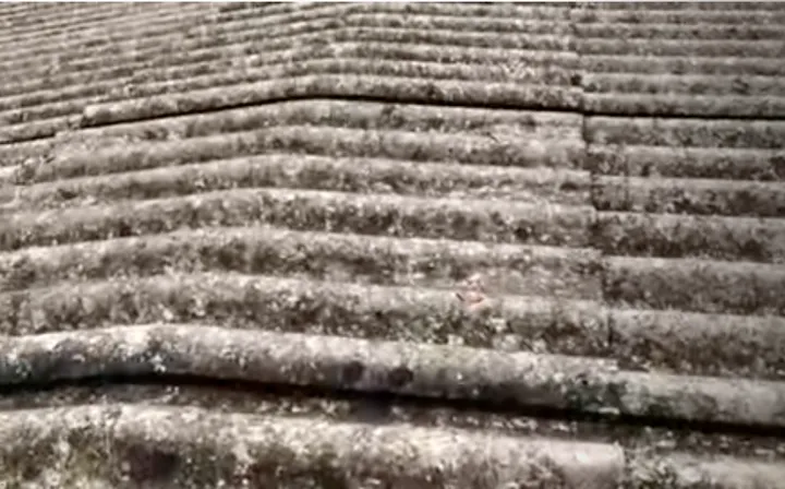 A weathered grey corrugated fibro / Super Six asbestos-cement sheet roof