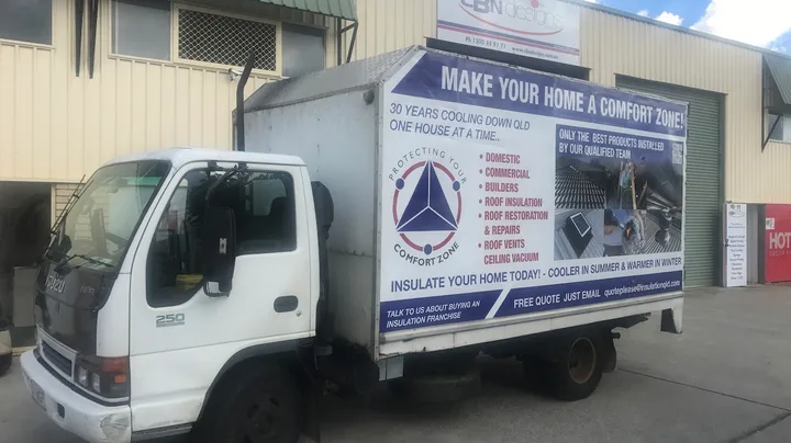The Comfort Zone Insulation box truck in full livery: "Make your home a Comfort Zone, 30 years cooling down QLD" — QLD