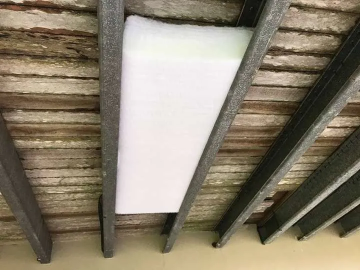 Self-supporting white polyester batt held firmly between steel floor joists under a raised floor, Tamborine